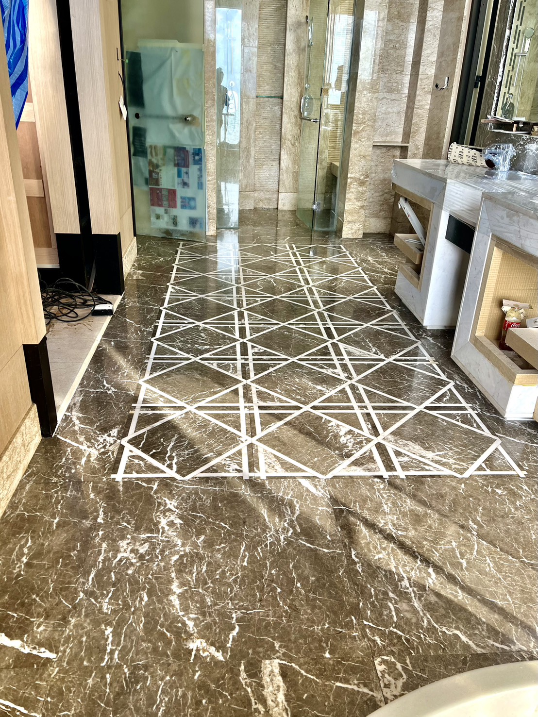 Completed geometric inlay marble floor restoration Conrad Koh Samui — results that satisfy our clients